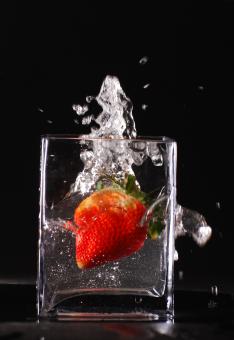 Free Stock Photo of Splashing strawberry in glass