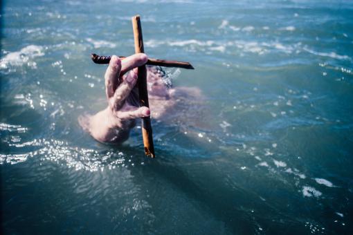 Free Stock Photo of Swimmer holding a cross