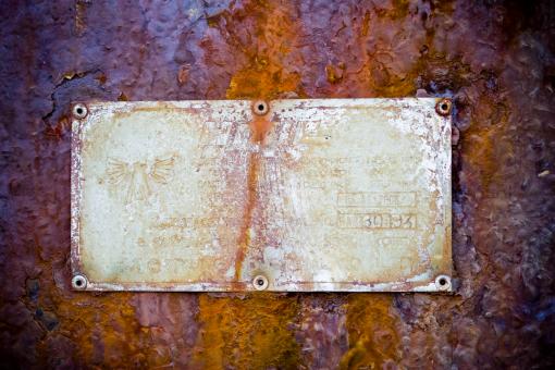 Free Stock Photo of Rusted Sign on Metal Background