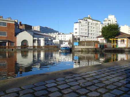 Free Stock Photo of View over a channel and new buildings. Rebuilt pavement in front