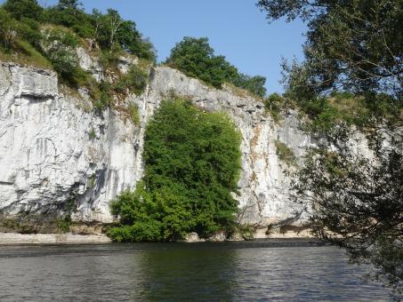 Free Stock Photo of White limestone cliff dug by a river