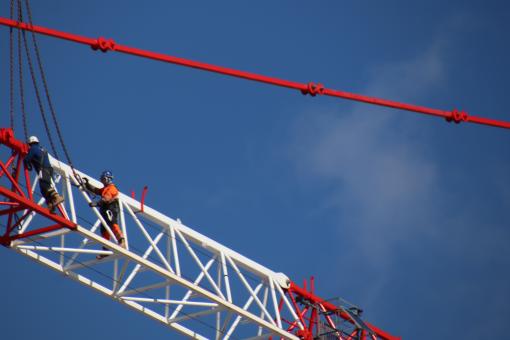 Free Stock Photo of Skilled workers disassembling a huge crane