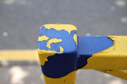 Free Stock Photo of Peeled yellow paint on blue rail