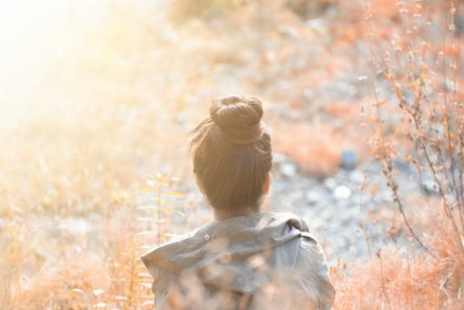 Free Stock Photo of Girl in Nature with Bun Hairstyle