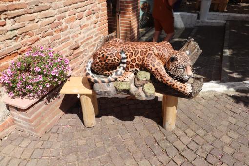 Free Stock Photo of Funny leopard sculpture near a restaurant