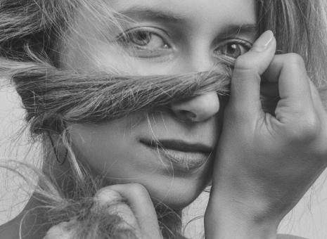 Free Stock Photo of Girl Holding Hair in Front of Face