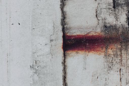 Free Stock Photo of Rust Leak on Cracked Stone Wall