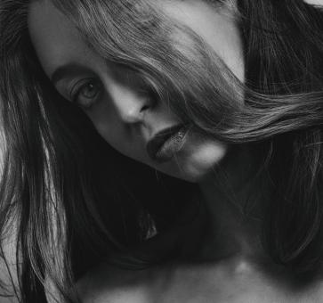 Free Stock Photo of Brunette Tilting Head - Black and White Portrait