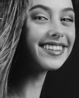 Free Stock Photo of Portrait of Smiling Young Girl - Monochrome