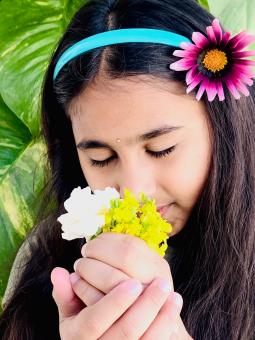Free Stock Photo of Indian girl smelling flowers
