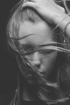 Free Stock Photo of Girl Model Holding Her Head - Hair Over Face