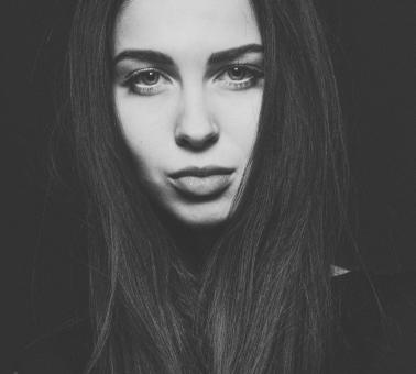 Free Stock Photo of Brunette on Dark Background - Monochrome