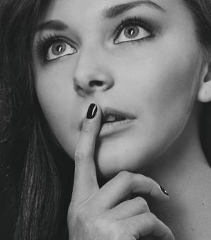 Free Stock Photo of Girl with Finger on Lips - Monochrome