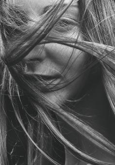 Free Stock Photo of Woman with Hair Covering Face - Monochrome Portrait