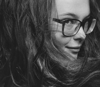 Free Stock Photo of Young Brunette with Glasses - Monochrome Portrait