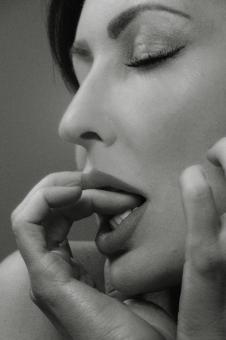 Free Stock Photo of Woman Monochrome Portrait - Fingers in Mouth