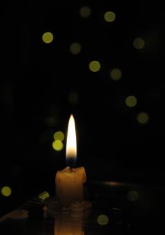 Free Stock Photo of Small candle with light yellow spots on light background