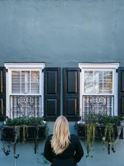 Free Stock Photo of Woman in front of a house