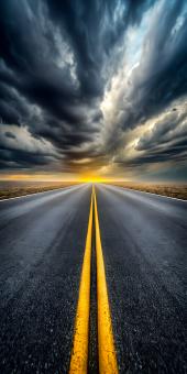Free Stock Photo of Road leading to the sunset under dramatic storm clouds