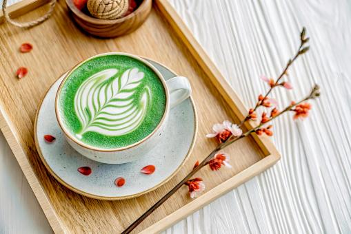 Free Stock Photo of Enjoying a Delicious Green Tea Latte on a Wooden Tray