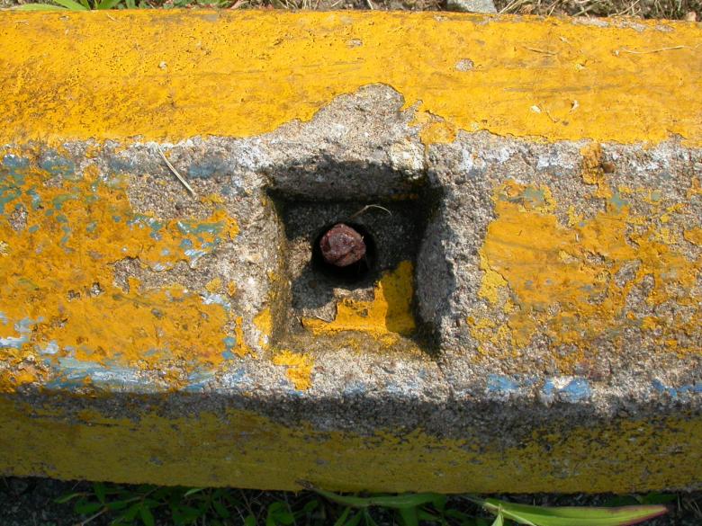Free stock image of Rusted bolt in yellow concrete wall created by raymond henry