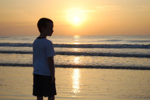 Free Stock Photo of Sunrise at beach with boy