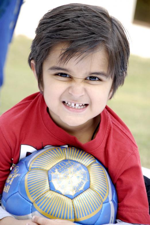Free stock image of Cute Kid With Football created by Bilal Aslam