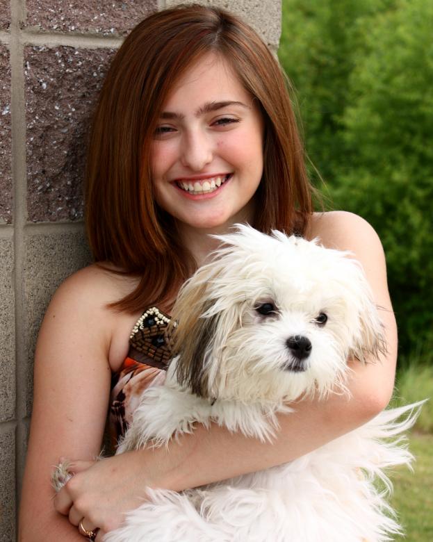 Free stock image of A young girl posing with a small dog created by Benjamin Miller