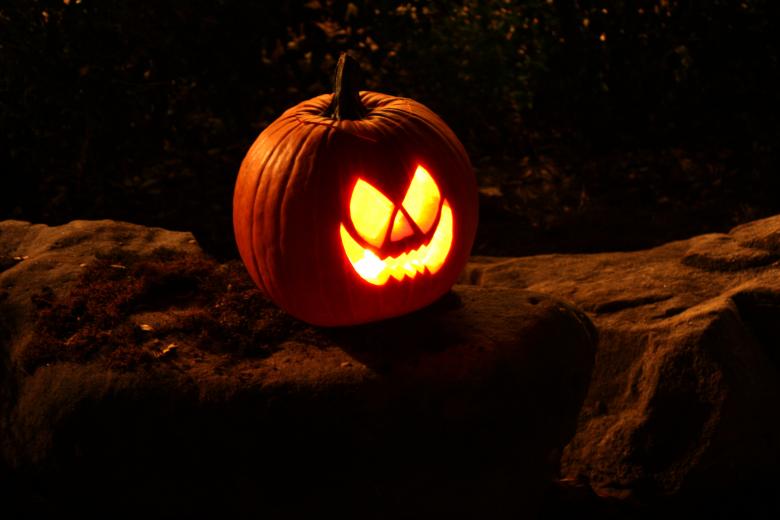 Free stock image of A Halloween jack-o-lantern on a rock created by Benjamin Miller