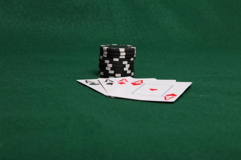 Free stock image of Stack of black poker chips with four ace created by Jared Davidson