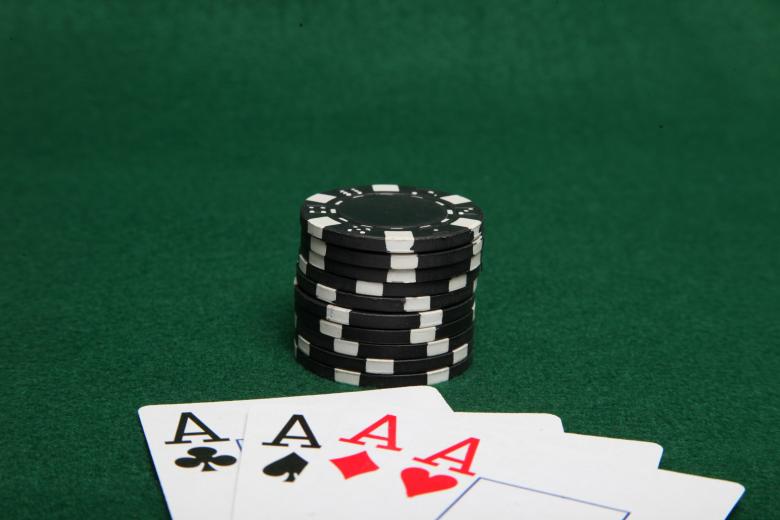 Free stock image of Stack of black poker chips with four ace created by Jared Davidson