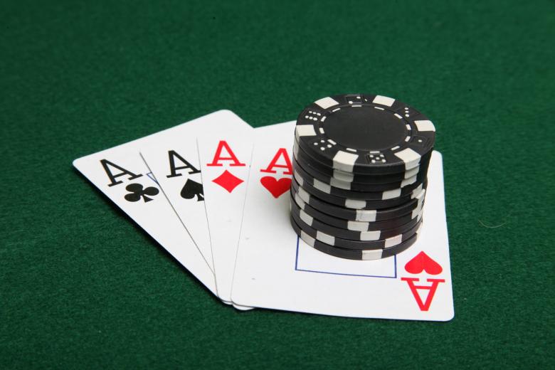 Free stock image of Stack of black poker chips on four aces created by Jared Davidson