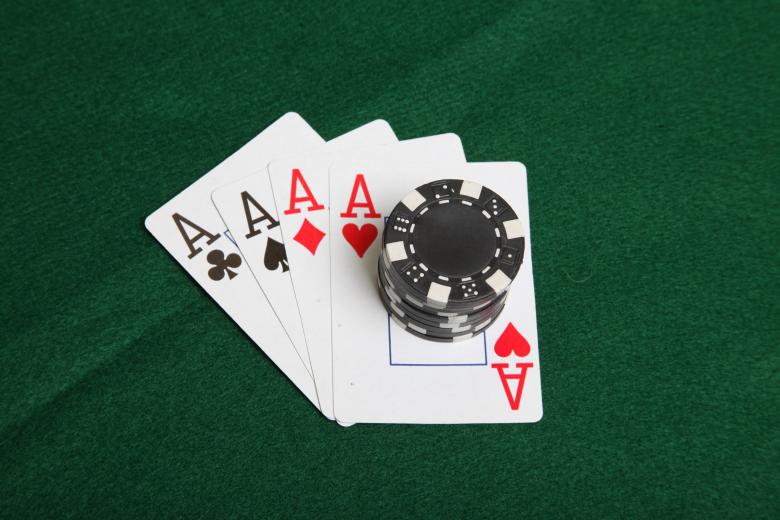 Free stock image of Stack of black poker chips on four aces. created by Jared Davidson