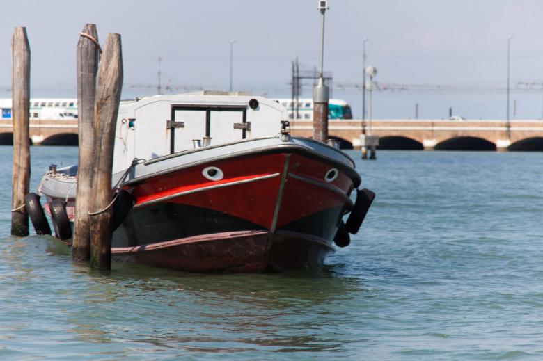 Free stock image of Moored boat with train in background created by Geoffrey Whiteway