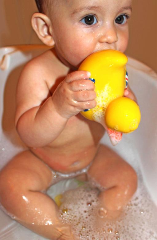 Free stock image of Baby bathing while holding and sucking a created by Jack Moreh