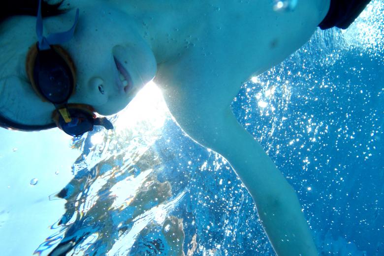 Free stock image of Child swimming underwater smiling created by Jack Moreh