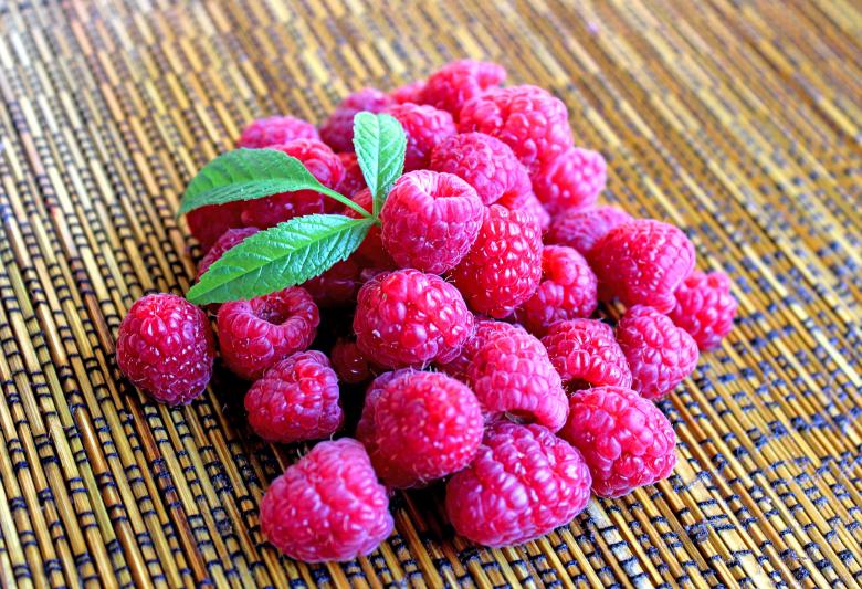 Free stock image of Raspberries on the table with leaves created by Jack Moreh