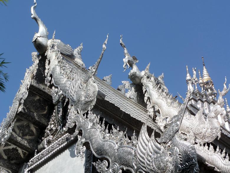 Free stock image of Ornate silvered Buddhist temple roof created by Chas Mac