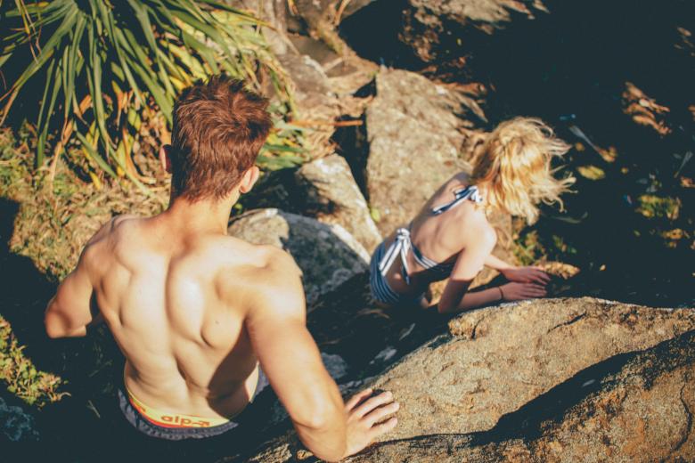 Free stock image of Boy and girl climbing down rocks created by StockSnap