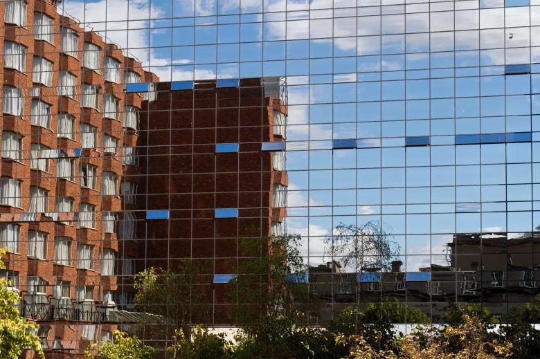 Free stock image of Brick Building in Glass Building Reflection created by Geoffrey Whiteway