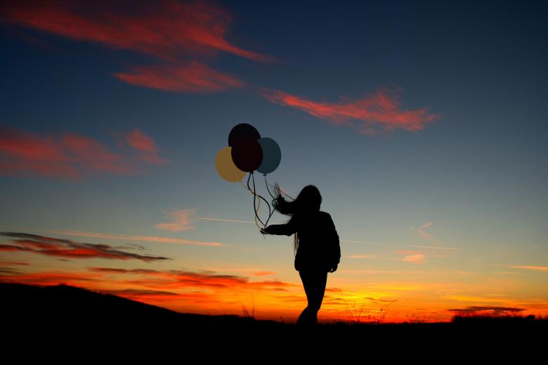 Free stock image of Girl holding balloons created by Pixabay