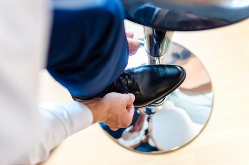 Man Putting on Shoes for Wedding