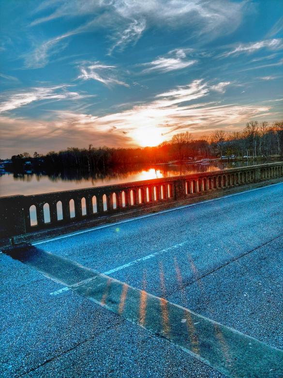 Free stock image of Evening sunset over bridge and river created by agphotostock.com