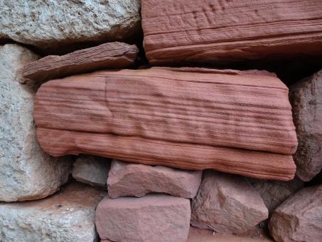 Free Stock Photo of Eroded red sandstone on dry stone wall