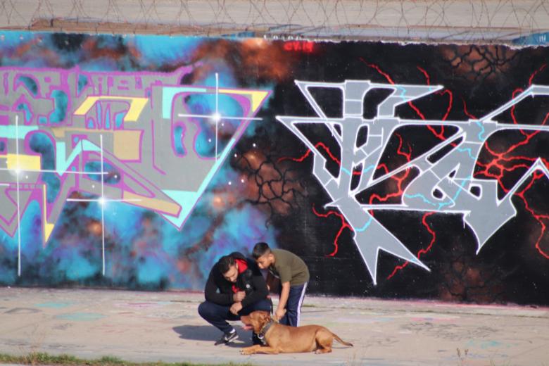 Free stock image of People with their dog, before a painted wall created by GAIMARD Jacques