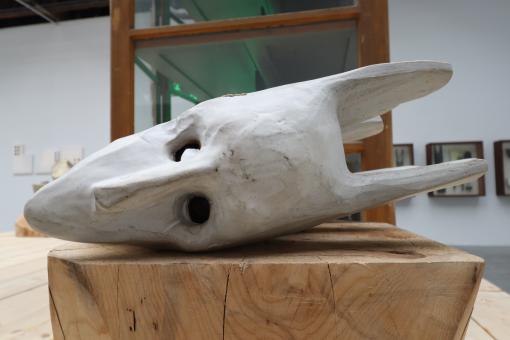 Free Stock Photo of White wood mask on a raw wood block