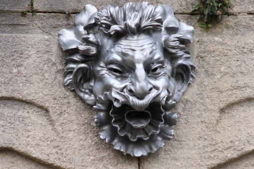 Free Stock Photo of Metal head sculpture in a public garden