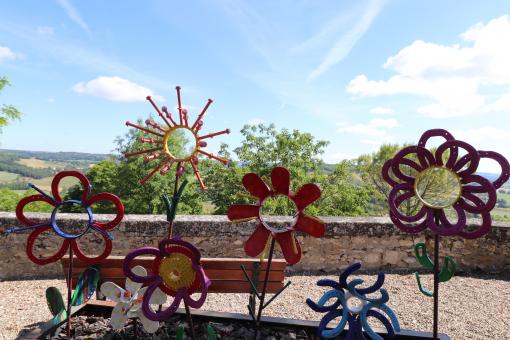 Various iron colored flower sculptures in a street - Free Stock Photo