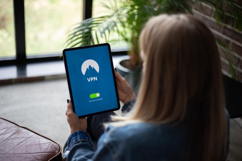 Free stock image of Woman holding tablet with VPN software created by Morthy