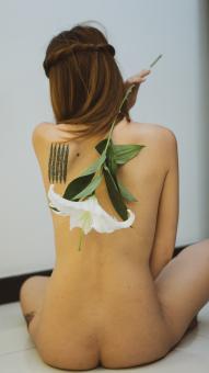 A Slender Woman With A Naked Back and Flower - Free Stock Photo